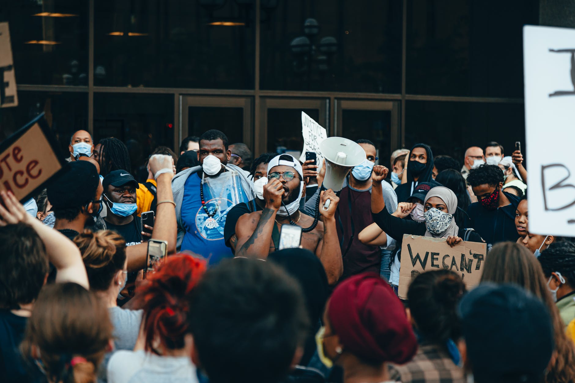 crowd of protesters holding signs