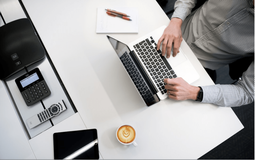 Business manager using sales account planning software at a desk